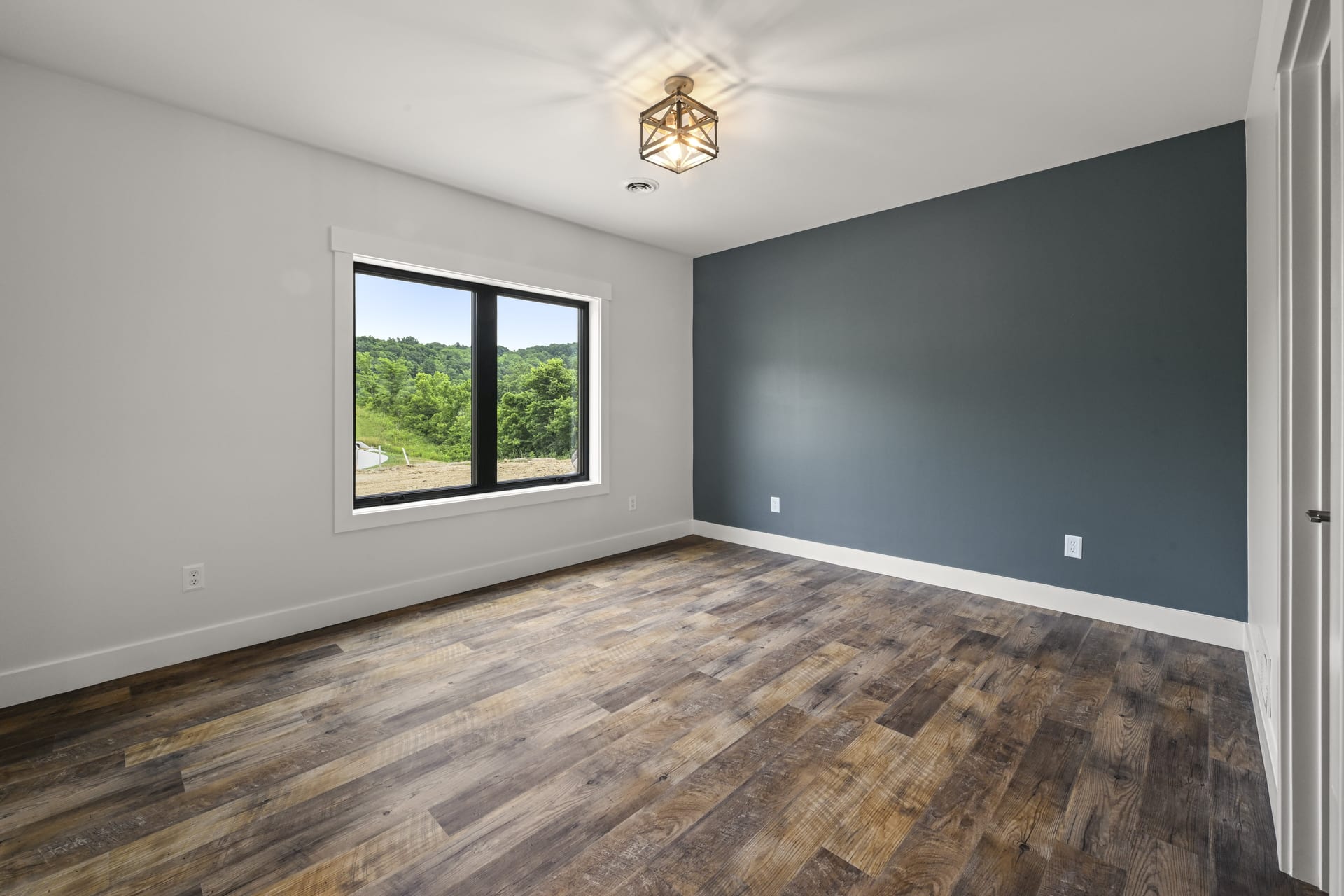 Guest bedroom with natural light in custom Indiana home